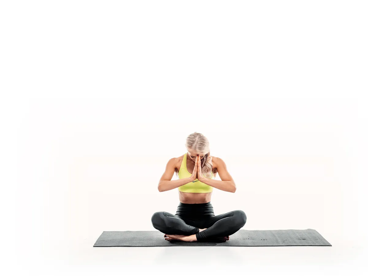 Seated yoga meditation pose photographed on white background