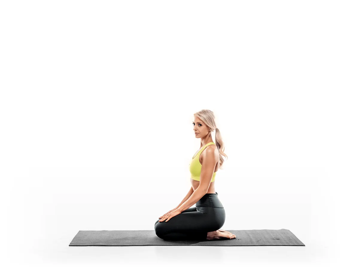 Pilates kneeling posture photographed on white studio background